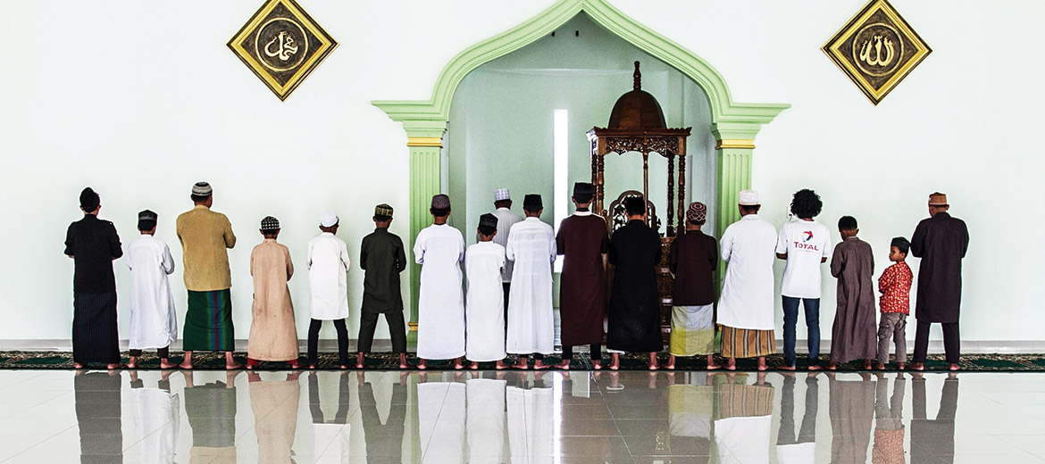 Men and boys pray at a mosque on the grounds of the Al-Hidayah school